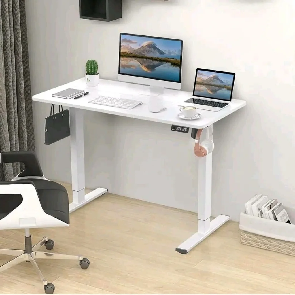 White electric standing desk in a bright home workspace